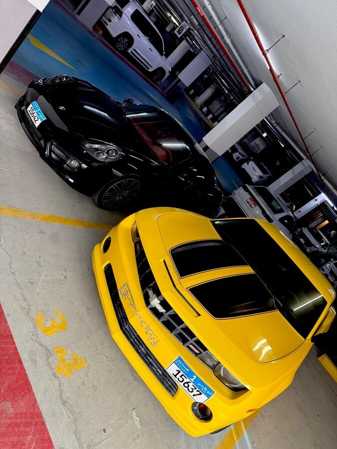 Chevrolet Camaro and Porsche in Dubai parking