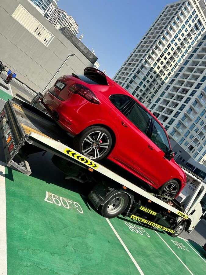 Red Jaguar on recovery truck Dubai