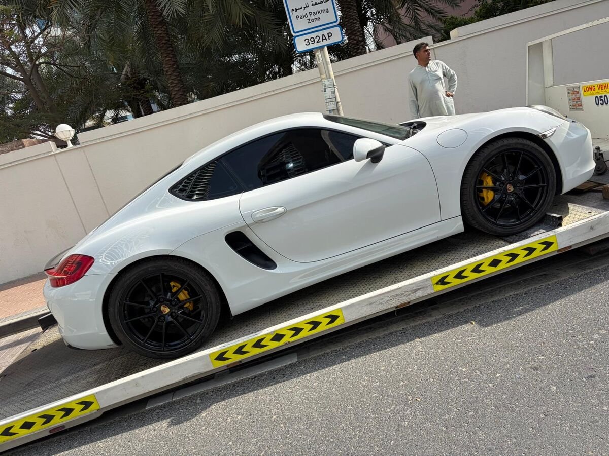 White Porsche Cayman on truck